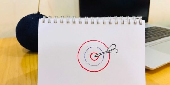 Drawing of a target that has been hit with a dart