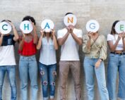 A group of young adults holding letters spelling out the word change