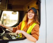Happy woman professional truck driver making deliveries